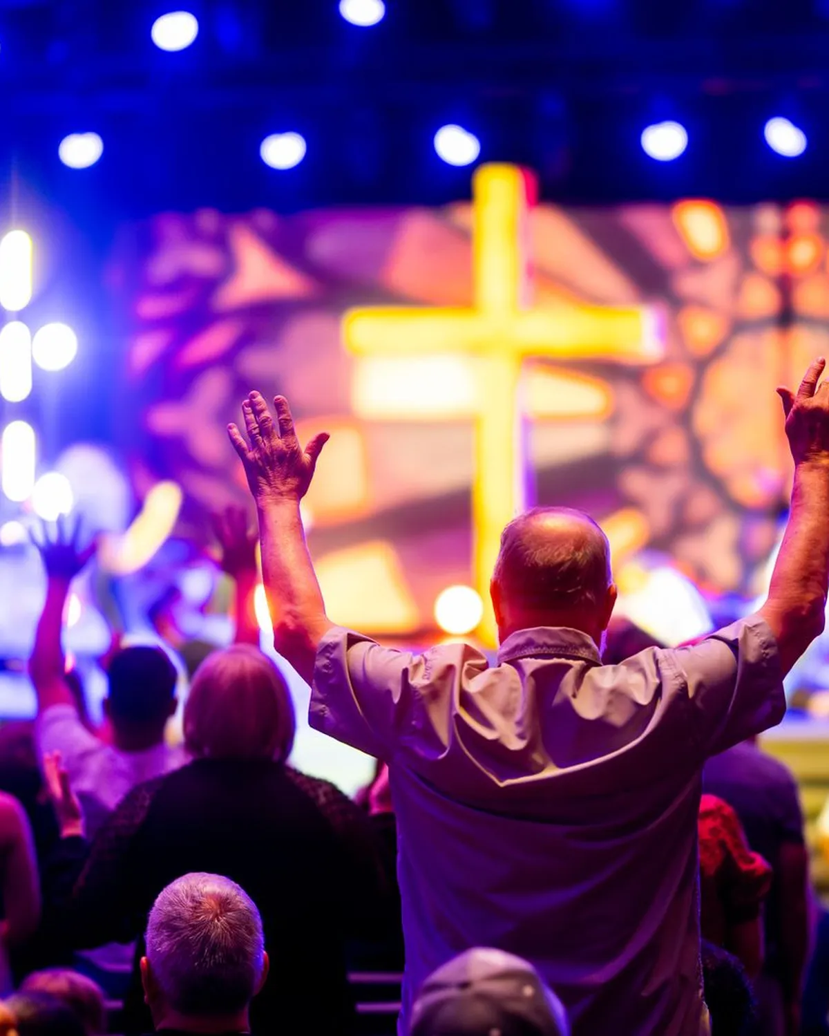 Church congregation worshipping with hands raised